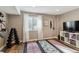 Bright home gym featuring wood floors, a window, weights, yoga mats and storage shelves under a TV for workouts at 1345 Laurel St, Broomfield, CO 80020