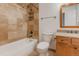 Bathroom features a shower-tub combo, granite countertops, and wood cabinets at 2727 Folsom St # 210, Boulder, CO 80304