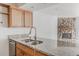 Open-concept view of kitchen granite countertops, stainless sink and fireplace in living area at 2727 Folsom St # 210, Boulder, CO 80304