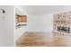 Living room with a stone fireplace and hardwood floors, complemented by an open kitchen at 2727 Folsom St # 210, Boulder, CO 80304