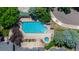 Overhead shot of a sparkling swimming pool with surrounding trees and greenery at 2727 Folsom St # 210, Boulder, CO 80304