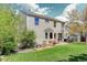 Spacious backyard with a well-maintained lawn, patio, fire pit, and outdoor seating area for relaxing and entertaining at 15432 Greenstone Cir, Parker, CO 80134