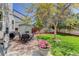 Serene backyard with mature tree, patio, lawn, and dining set, perfect for outdoor gatherings and enjoying nature at 15432 Greenstone Cir, Parker, CO 80134