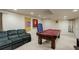 Basement game room with a pool table and large dark green sofa at 15432 Greenstone Cir, Parker, CO 80134