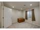 Minimalist bedroom featuring a window with curtains, a door and a wooden chest at 15432 Greenstone Cir, Parker, CO 80134