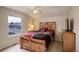 Comfortable bedroom with ceiling fan, a window view, and traditional wood bedroom furniture at 15432 Greenstone Cir, Parker, CO 80134