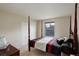Well-lit bedroom with a four-poster bed, window, and closet doors providing ample storage at 15432 Greenstone Cir, Parker, CO 80134