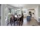 Bright dining area adjacent to a modern kitchen, featuring large windows and a spacious layout for gatherings at 15432 Greenstone Cir, Parker, CO 80134