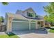Lovely home with a three-car garage, brick accents, and a cozy front porch perfect for relaxing at 15432 Greenstone Cir, Parker, CO 80134