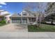Charming two-story home showcasing a well-manicured lawn, brick accents, and a three car garage at 15432 Greenstone Cir, Parker, CO 80134