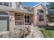 Inviting front porch with stone landscaping and patriotic decor, perfect for enjoying quiet moments at 15432 Greenstone Cir, Parker, CO 80134
