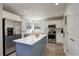 A contemporary kitchen featuring stainless steel appliances, white cabinets, and a center island with a sleek white countertop at 15432 Greenstone Cir, Parker, CO 80134