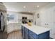 Bright kitchen with white cabinets, stainless appliances and a large center island perfect for cooking and entertaining at 15432 Greenstone Cir, Parker, CO 80134