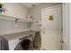Laundry room featuring a side-by-side washer and dryer with a white shelf above at 15432 Greenstone Cir, Parker, CO 80134