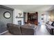 Cozy living room with painted brick fireplace, hardwood floors, entertainment center, and ample seating at 15432 Greenstone Cir, Parker, CO 80134