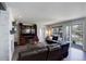 Comfortable living room with fireplace, hardwood floors, large television, and access to the outdoor space at 15432 Greenstone Cir, Parker, CO 80134