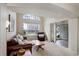 Bright living room with large window and comfortable seating arrangement at 15432 Greenstone Cir, Parker, CO 80134