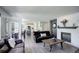 Open-concept living room with hardwood floors, fireplace, and seamless flow into the dining and kitchen areas at 15432 Greenstone Cir, Parker, CO 80134