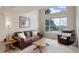 Bright living room featuring a vaulted ceiling, large windows, and comfortable seating at 15432 Greenstone Cir, Parker, CO 80134
