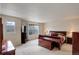 Main bedroom with large bed, bedside tables, and windows at 15432 Greenstone Cir, Parker, CO 80134