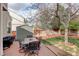 Outdoor dining area on a brick patio, complete with a table, chairs, and a grill at 15432 Greenstone Cir, Parker, CO 80134