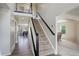 Elegant staircase leading to the upper level, complemented by neutral décor and an open floor plan at 15432 Greenstone Cir, Parker, CO 80134
