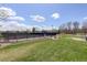 Community tennis courts with green lawn and picnic tables at 15432 Greenstone Cir, Parker, CO 80134