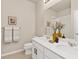 Bright bathroom featuring double sinks, framed art and decor at 113 Marlowe Dr, Erie, CO 80516