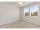 Carpeted bedroom features large windows and neutral walls at 113 Marlowe Dr, Erie, CO 80516