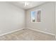 Neutral carpeted bedroom featuring a ceiling fan and a large window at 113 Marlowe Dr, Erie, CO 80516