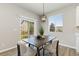 Inviting dining area with stylish lighting, room for 4 and sliding doors to the yard at 113 Marlowe Dr, Erie, CO 80516