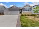 Charming gray two-story home with a two car garage and well-manicured lawn at 113 Marlowe Dr, Erie, CO 80516
