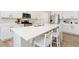 Spacious kitchen island with quartz countertops, stainless steel appliances and eat-in seating at 113 Marlowe Dr, Erie, CO 80516