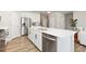 Modern kitchen with stainless steel appliances, white cabinets, and an open design at 113 Marlowe Dr, Erie, CO 80516
