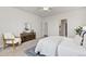 Bright main bedroom with white ceiling fan, wood chair, modern decor and an ensuite bathroom entrance at 113 Marlowe Dr, Erie, CO 80516
