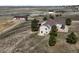 Aerial view of property with large house, barn and rolling landscape at 43097 Taos Trl, Elizabeth, CO 80107