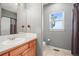 Bathroom with a shower/tub combo, window, toilet, and wood vanity at 43097 Taos Trl, Elizabeth, CO 80107