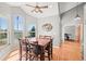 Bright dining room features large windows, hardwood floors, and a stylish ceiling fan at 43097 Taos Trl, Elizabeth, CO 80107