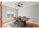 Well-lit dining room with hardwood floors, rustic table, and views of the surrounding landscape at 43097 Taos Trl, Elizabeth, CO 80107