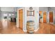 Inviting entryway featuring hardwood floors, decorative barrel, and archway to the kitchen at 43097 Taos Trl, Elizabeth, CO 80107