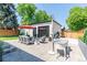 Beautiful backyard featuring a patio, dining area, outdoor seating and a modern shed with garage door at 4467 King St, Denver, CO 80211