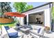 Backyard garage features open glass door, opening to a gym. A backyard patio is situated outside at 4467 King St, Denver, CO 80211
