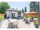 Inviting backyard featuring a stone patio with outdoor seating and a dining table, perfect for entertaining at 4467 King St, Denver, CO 80211