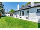 Expansive backyard featuring lush green lawn and a charming white brick home exterior at 4467 King St, Denver, CO 80211