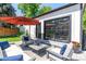 Relaxing backyard patio featuring an orange umbrella, outdoor sofa and chairs, with stone accents at 4467 King St, Denver, CO 80211