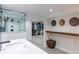 Bright bathroom with walk-in shower, modern vanity, walk-in closet and shelving at 4467 King St, Denver, CO 80211