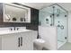 Modern basement bathroom with black and white tile, glass shower and updated fixtures at 4467 King St, Denver, CO 80211