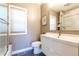 Stylish bathroom with sleek vanity, modern fixtures, shower with glass door and tile floor at 4467 King St, Denver, CO 80211