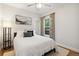 Cozy bedroom features a neutral color palette with lots of natural light and wood flooring at 4467 King St, Denver, CO 80211
