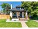 Charming home with a cozy front porch, manicured lawn, and inviting curb appeal at 4467 King St, Denver, CO 80211